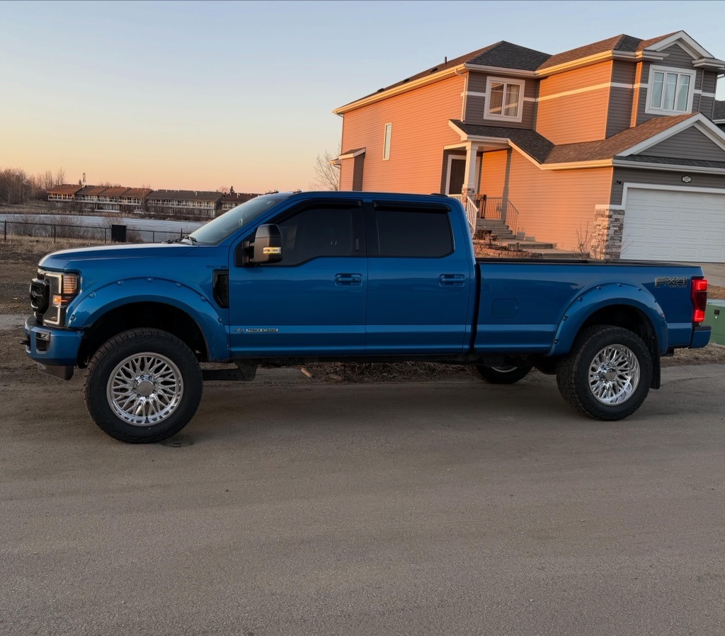 Blue Ford Super Duty dually on forged wheels