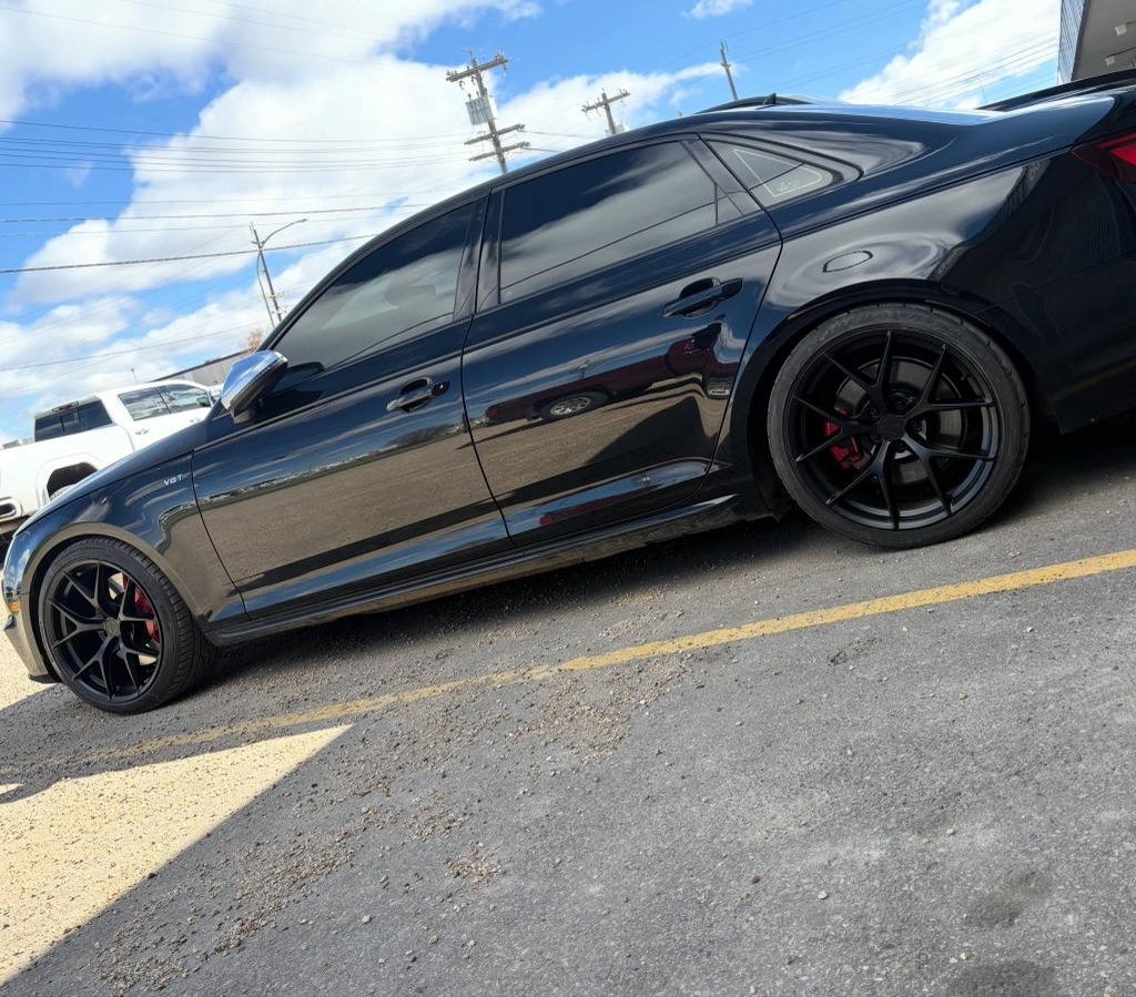 Black Audi sedan on matte black performance wheels