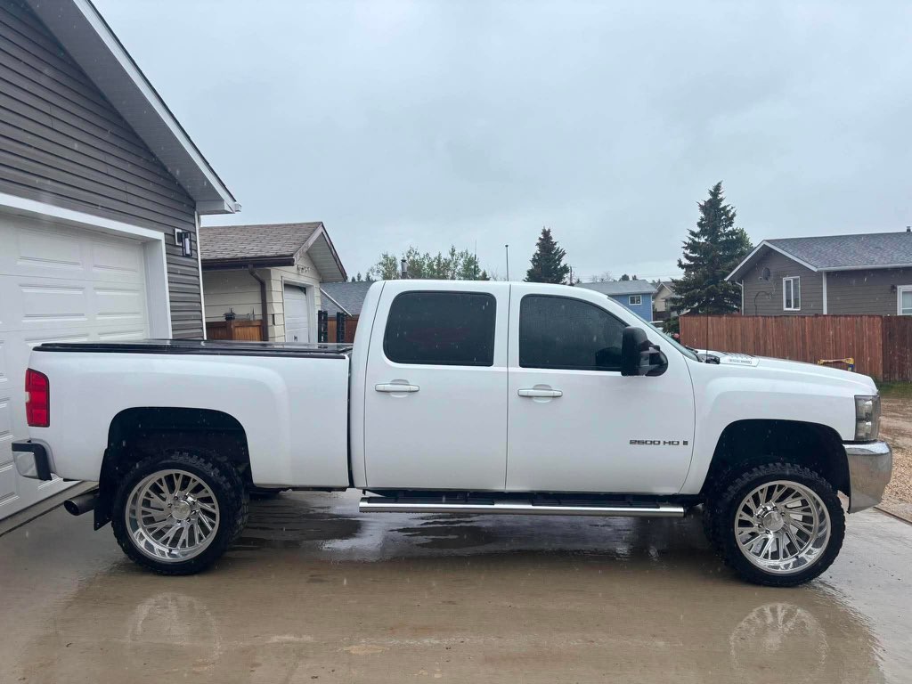 White Chevrolet Silverado 2500 HD on chrome forged wheels