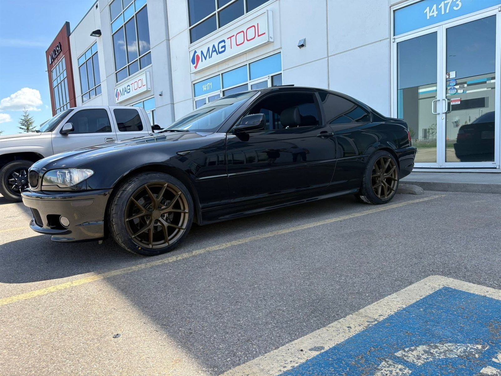 Black BMW 3 Series coupe lowered on bronze concave wheels